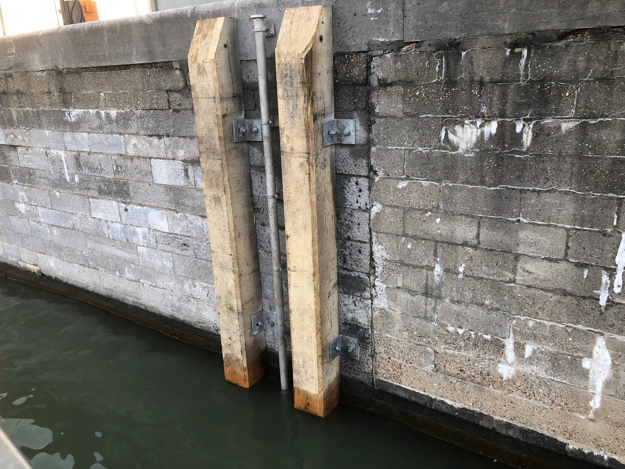 Maintenance and repair of pipe on a quay wall